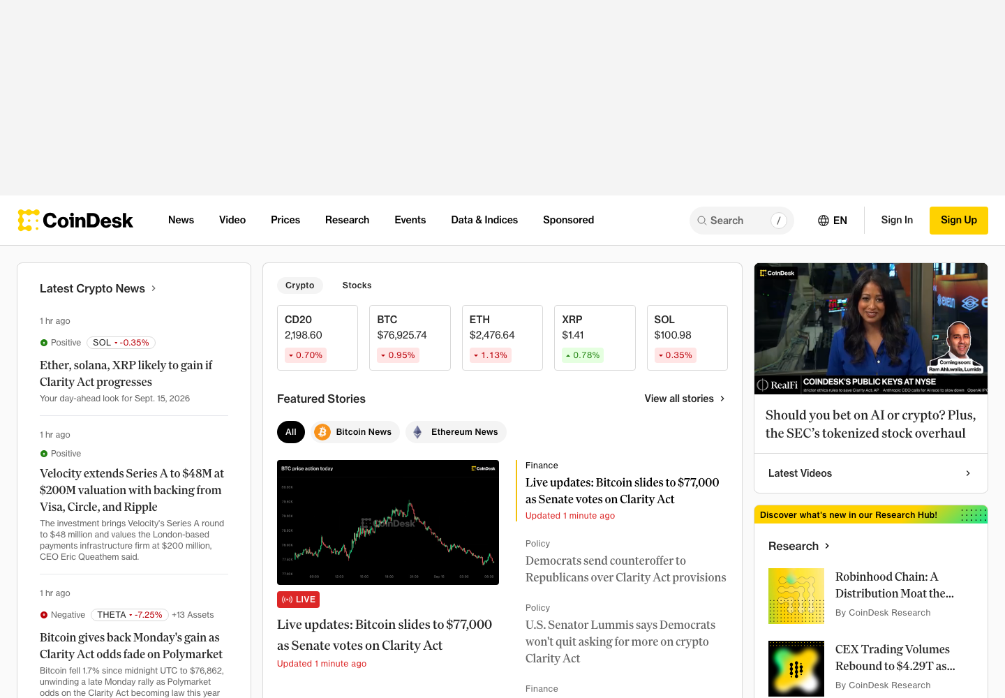 CoinDesk's homepage, showing live BTC, ETH, XRP and SOL prices above a grid of breaking stories on the Clarity Act vote